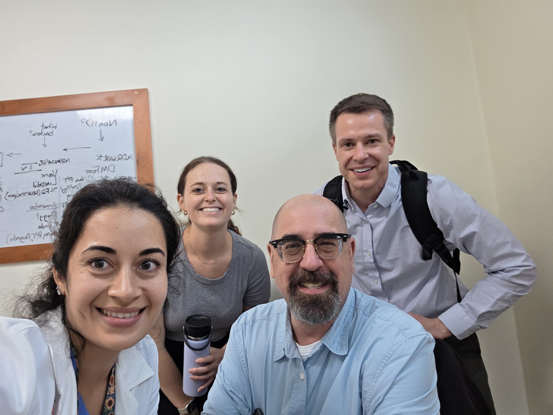 Four people in front of camera